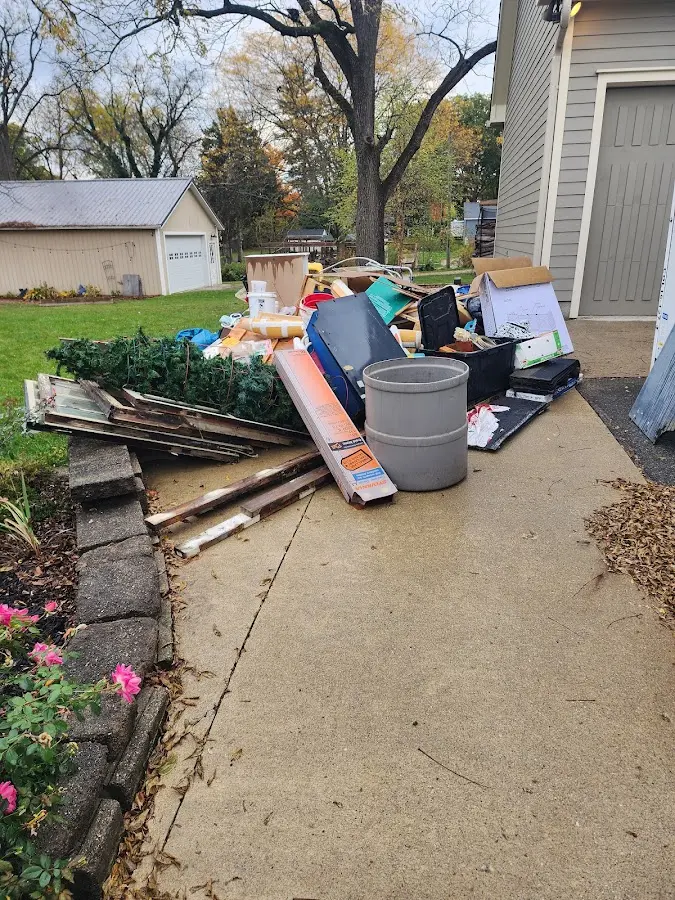 Dumpster being loaded with debris for Roofing Dumpster Rental in Chandler